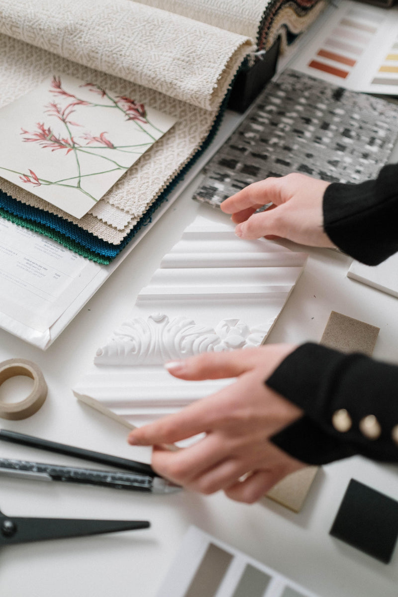 Woman's hands putting down a ceramic tile