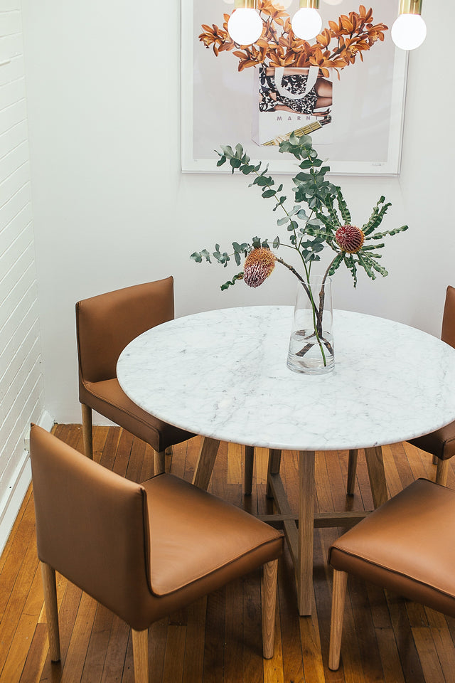 Modern dining round white table with brown chairs